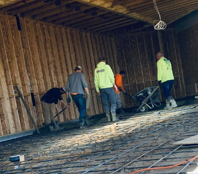 Crew working over reinforcement inside a framed structure