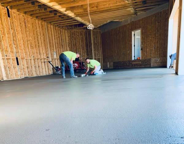 Crew finishing a large interior concrete slab