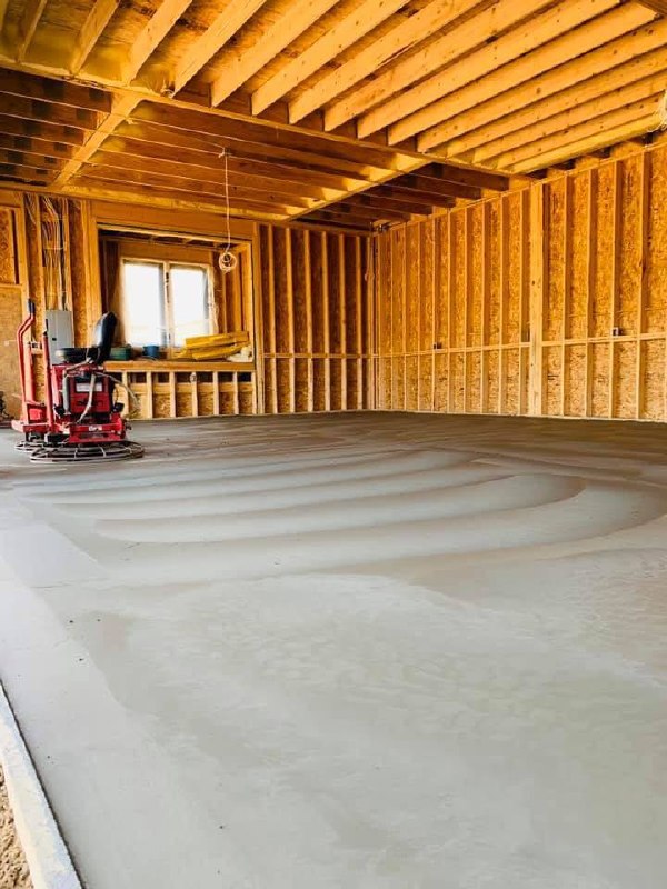 Finished interior concrete slab inside a framed structure