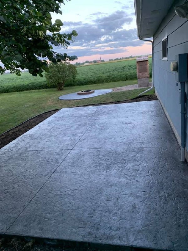 Completed stamped-concrete patio beside a house